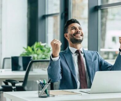 Business owner celebrating online lead generation success using digital marketing strategies